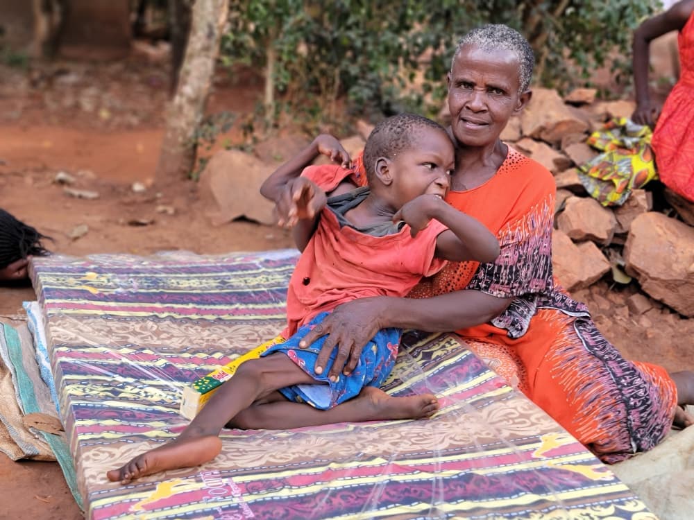 Group of children reading books together outdoors.
